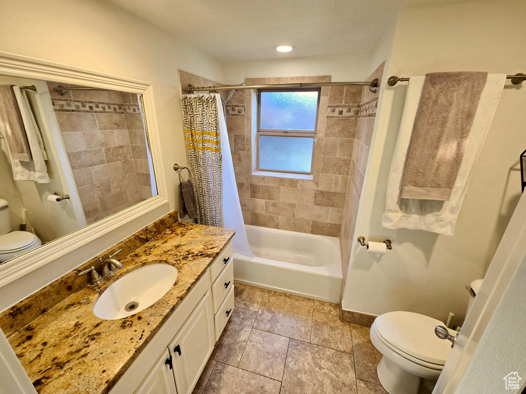 Full bathroom with vanity and shower / bath combination with curtain