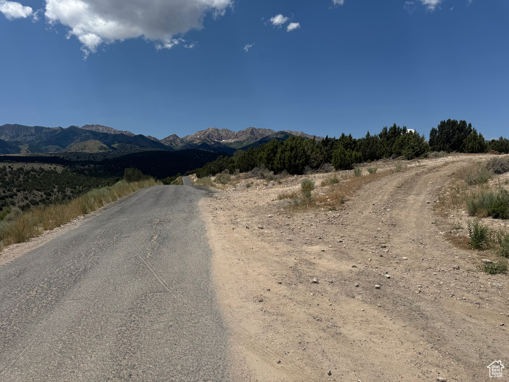 View of asphalt street featuring a mountain view