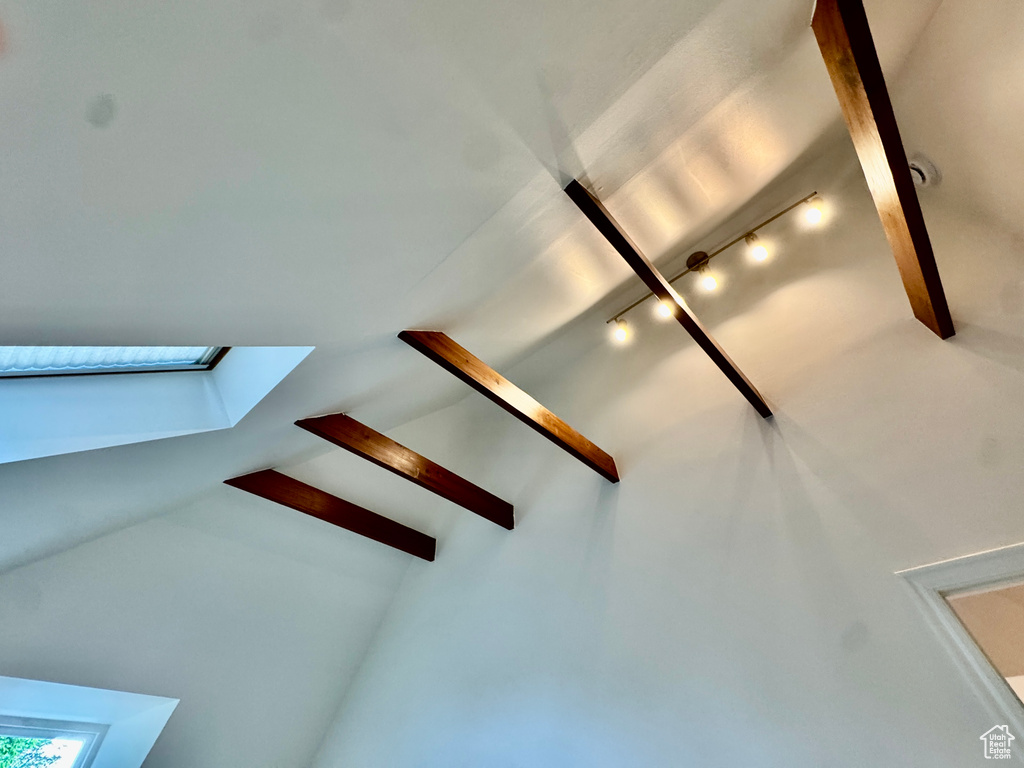 Detailed view of beamed ceiling, track lighting, and a skylight
