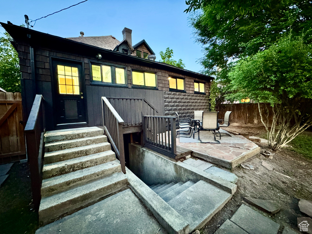 Back of property featuring a fenced backyard and a chimney