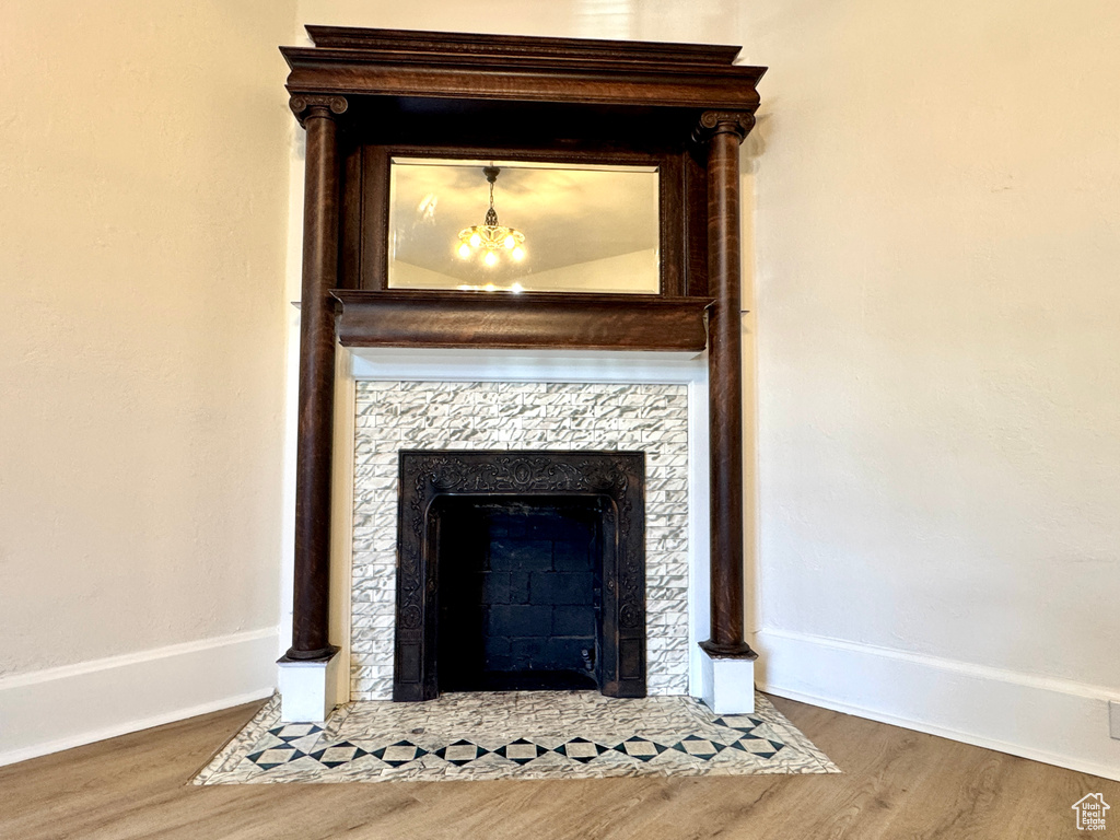 Detailed view of a fireplace with flush hearth and wood finished floors