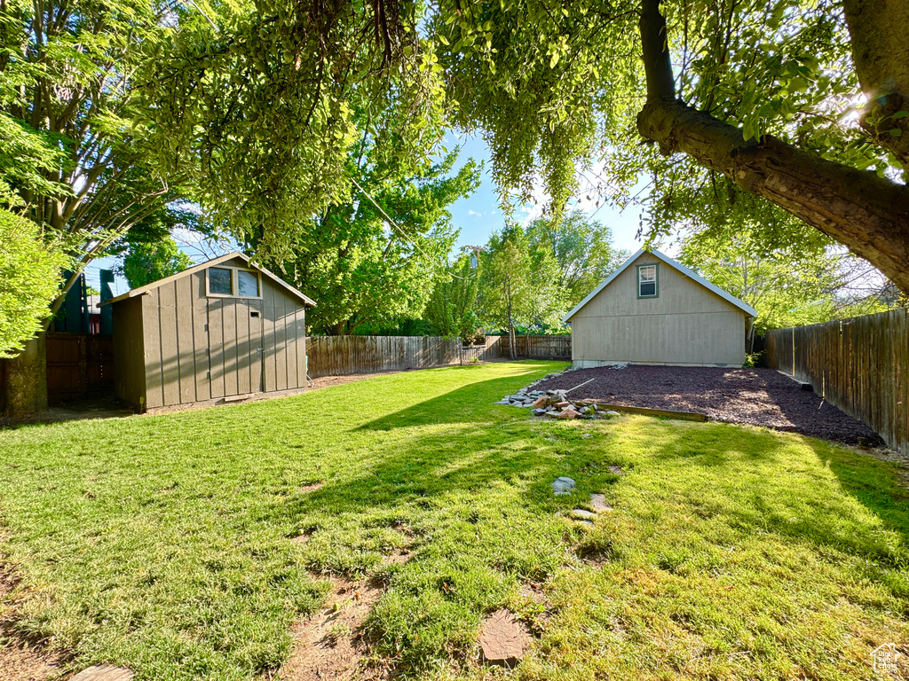 Fenced backyard with a storage shed