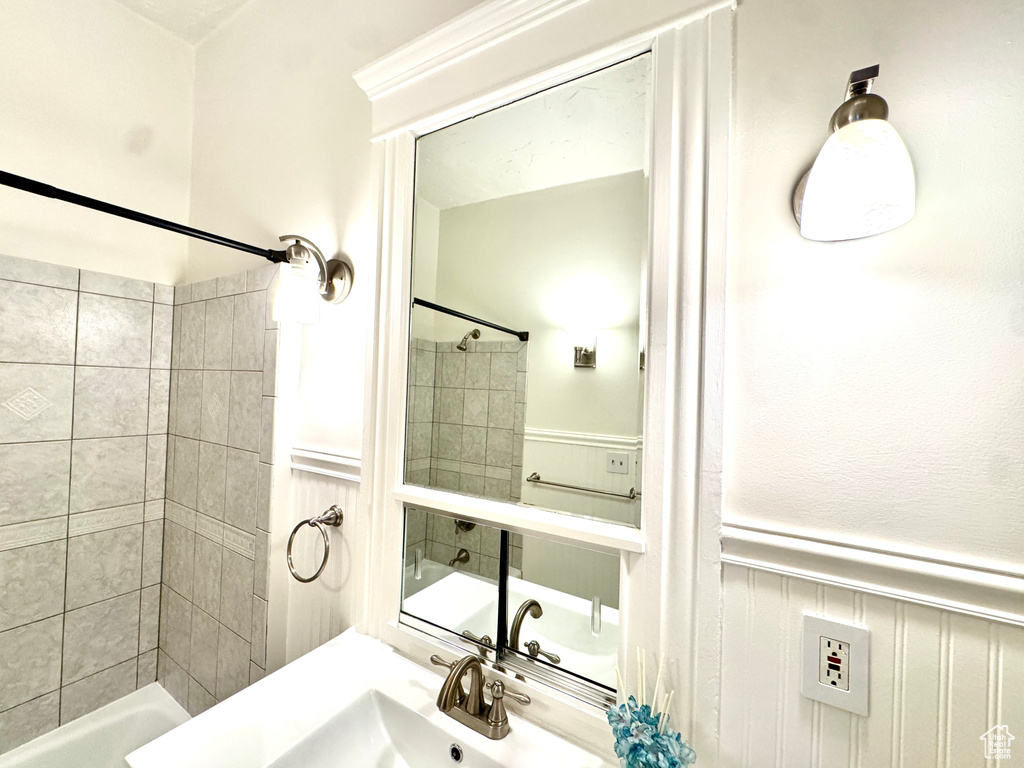 Full bath featuring wainscoting