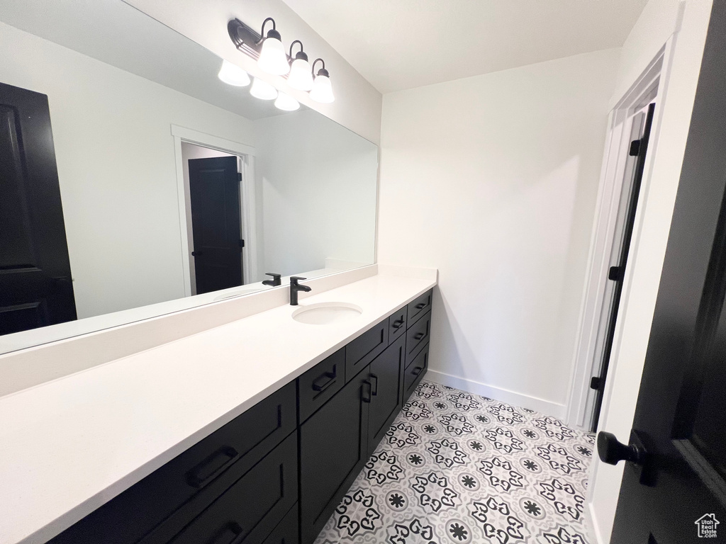 Bathroom featuring vanity and tile patterned flooring