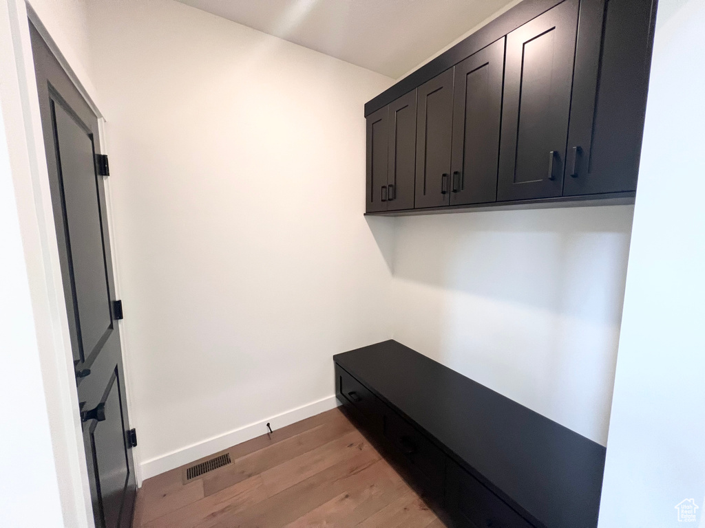 Mudroom featuring light wood finished floors and baseboards