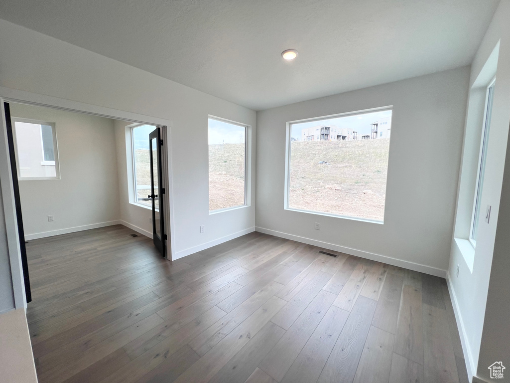 Spare room featuring dark wood-type flooring and recessed lighting