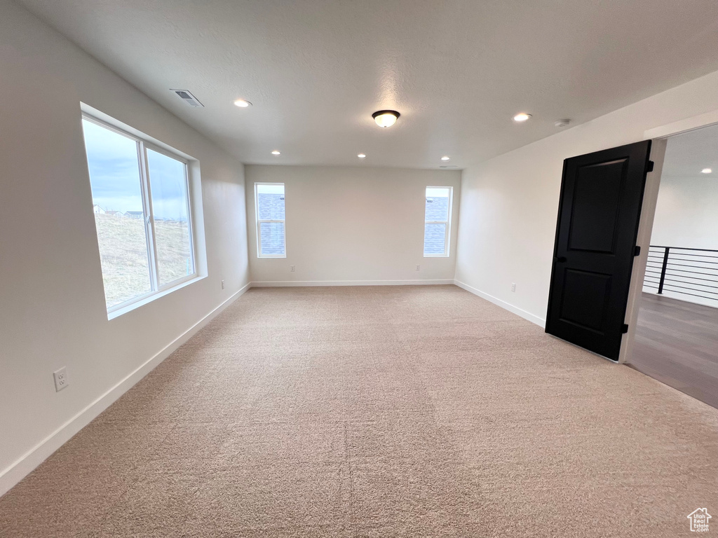Unfurnished room featuring recessed lighting and light colored carpet