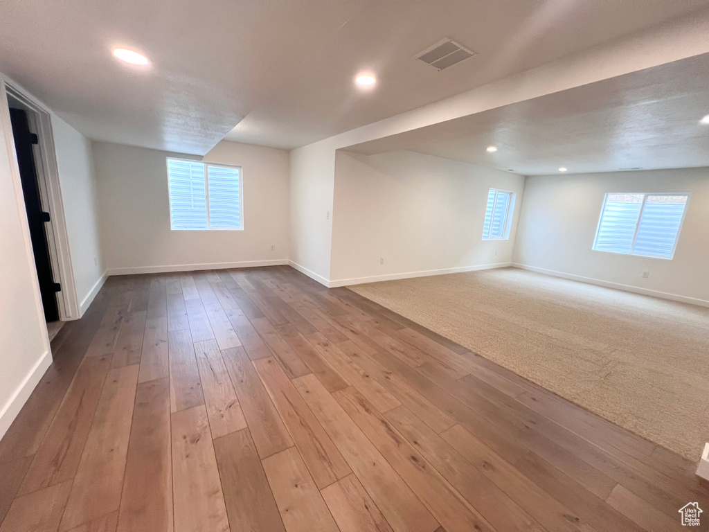 Spare room with hardwood / wood-style flooring and recessed lighting