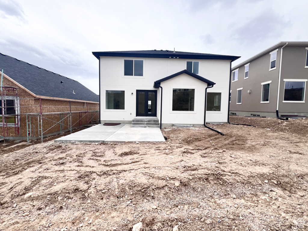 Rear view of property featuring a patio and stucco siding