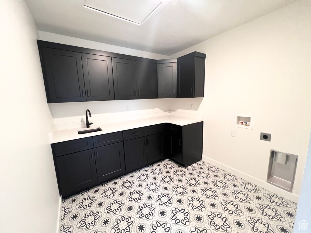 Laundry room featuring electric dryer hookup, hookup for a washing machine, and cabinet space