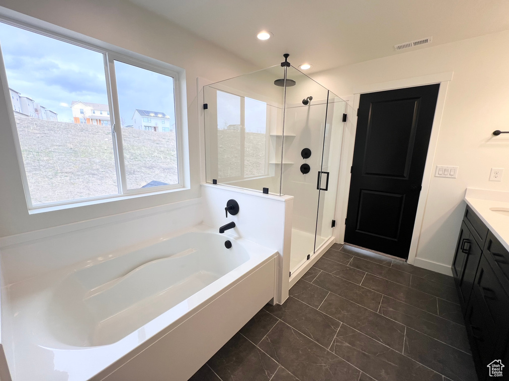 Full bath featuring a stall shower, a bath, vanity, and recessed lighting