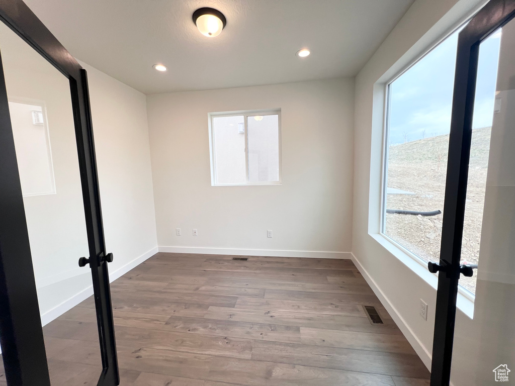 Unfurnished room featuring wood finished floors and recessed lighting