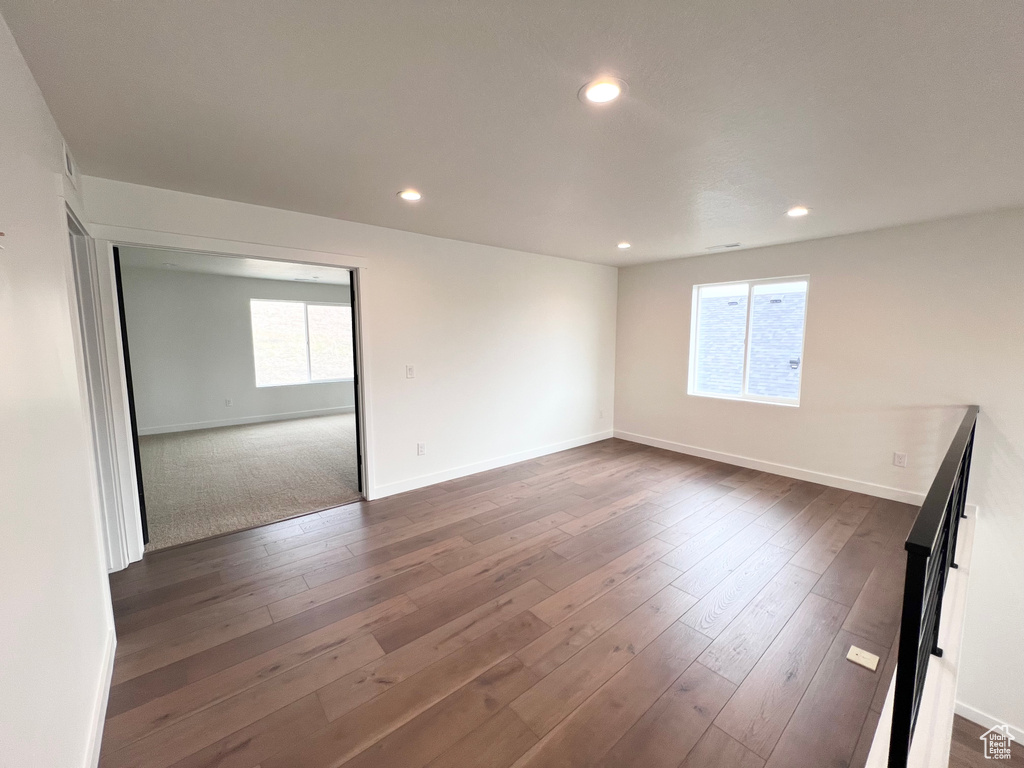 Spare room featuring recessed lighting and dark wood finished floors