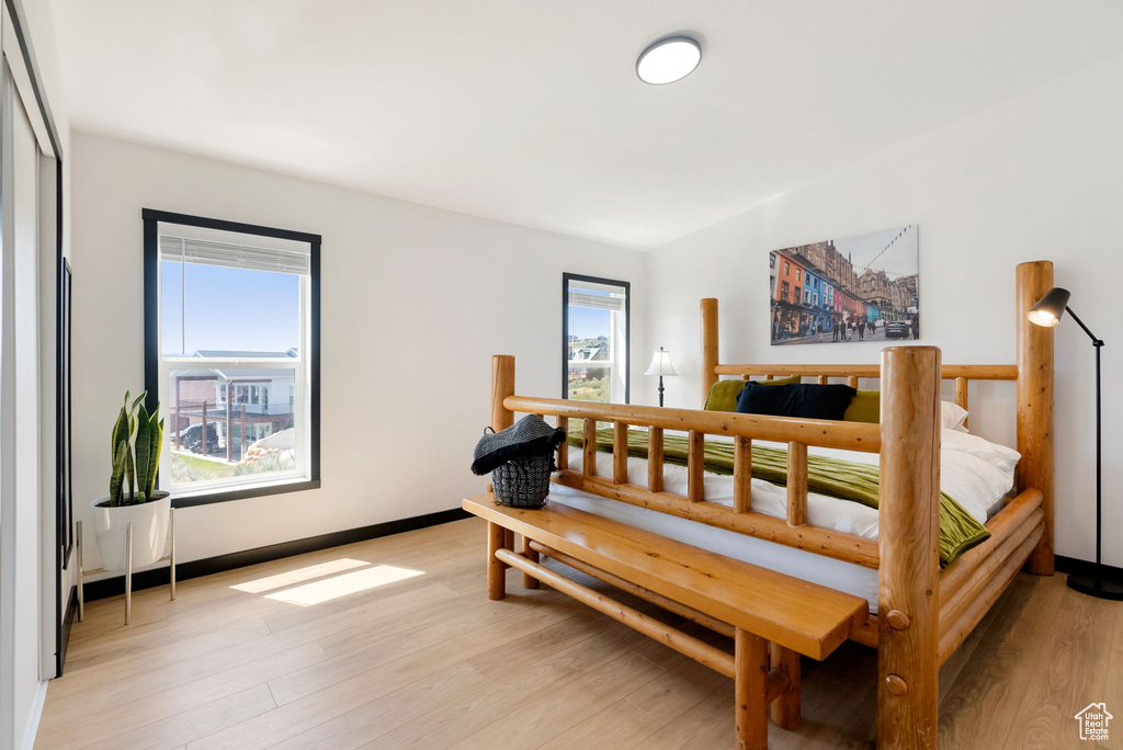 Bedroom with light wood-type flooring and baseboards