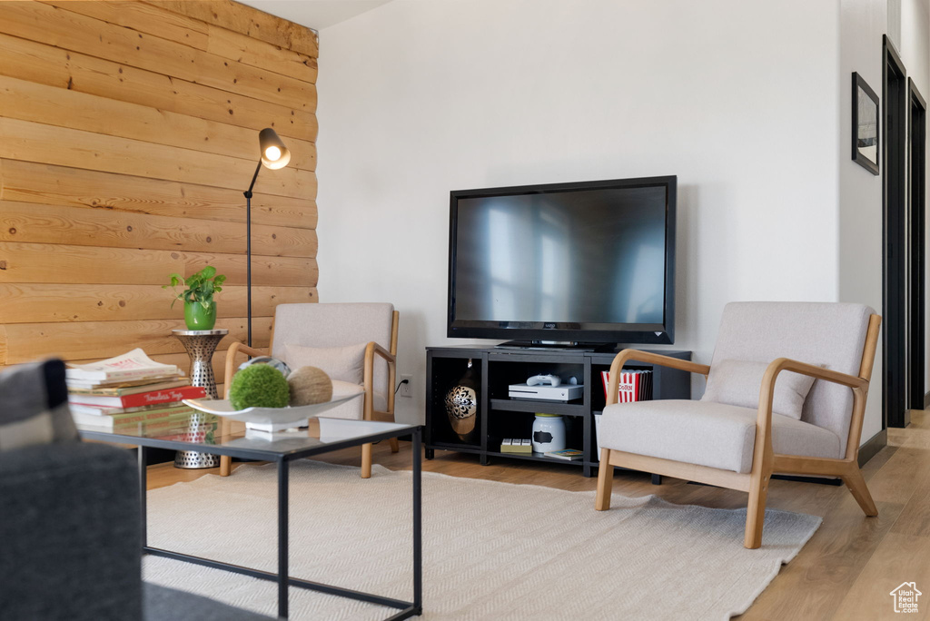 Living room with wooden walls and wood finished floors