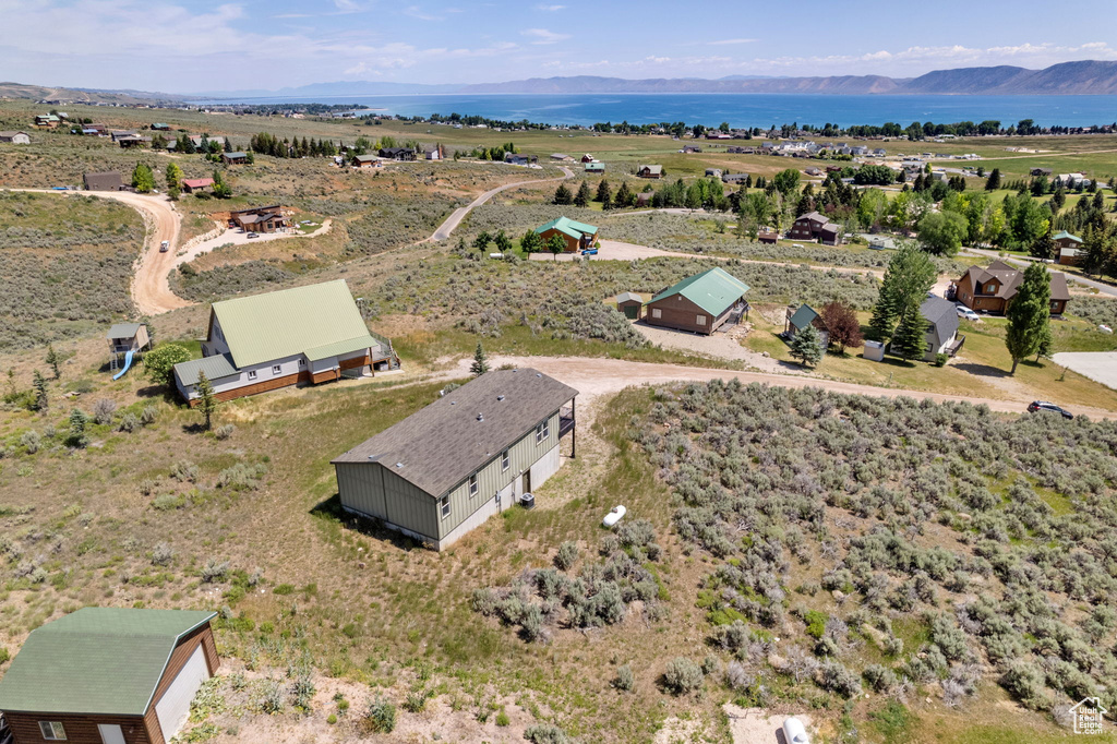 View from above of property with a water and mountain view