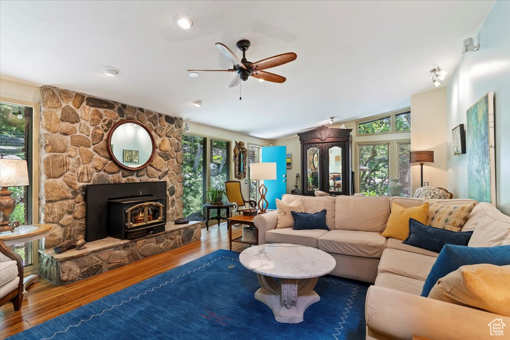 Living room featuring plenty of natural light, wood finished floors, and a ceiling fan