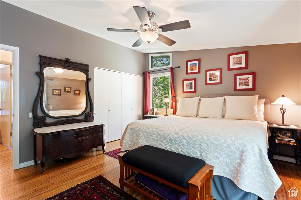 Bedroom with wood finished floors, a closet, and a ceiling fan