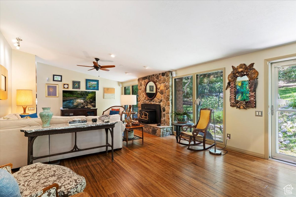 Living area featuring wood finished floors, a ceiling fan, and lofted ceiling
