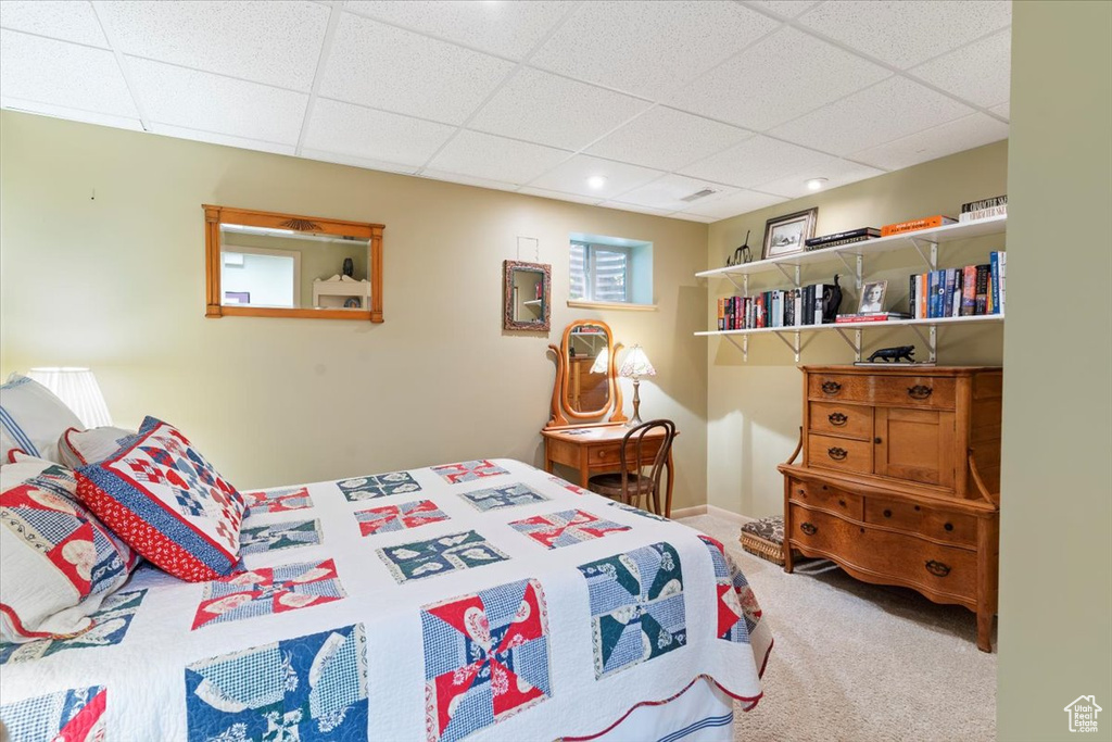 Bedroom featuring carpet floors and a paneled ceiling