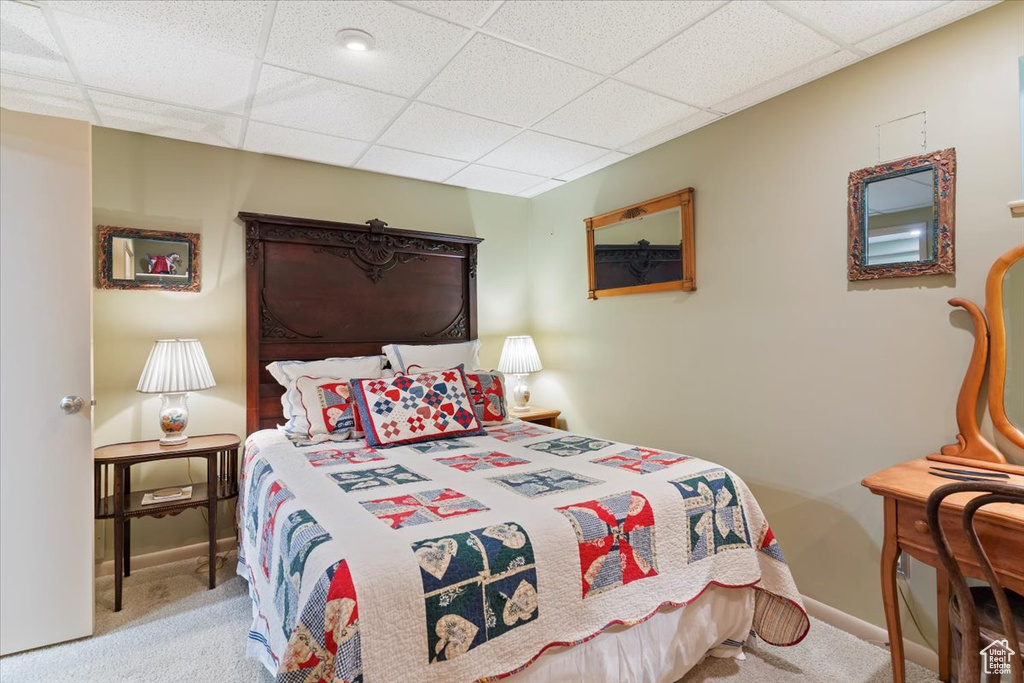 Carpeted bedroom with a drop ceiling
