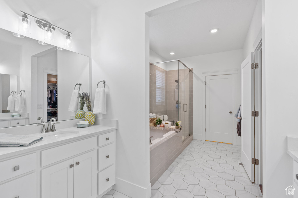 Bathroom featuring a shower stall, vanity, tile patterned floors, a bathtub, and recessed lighting
