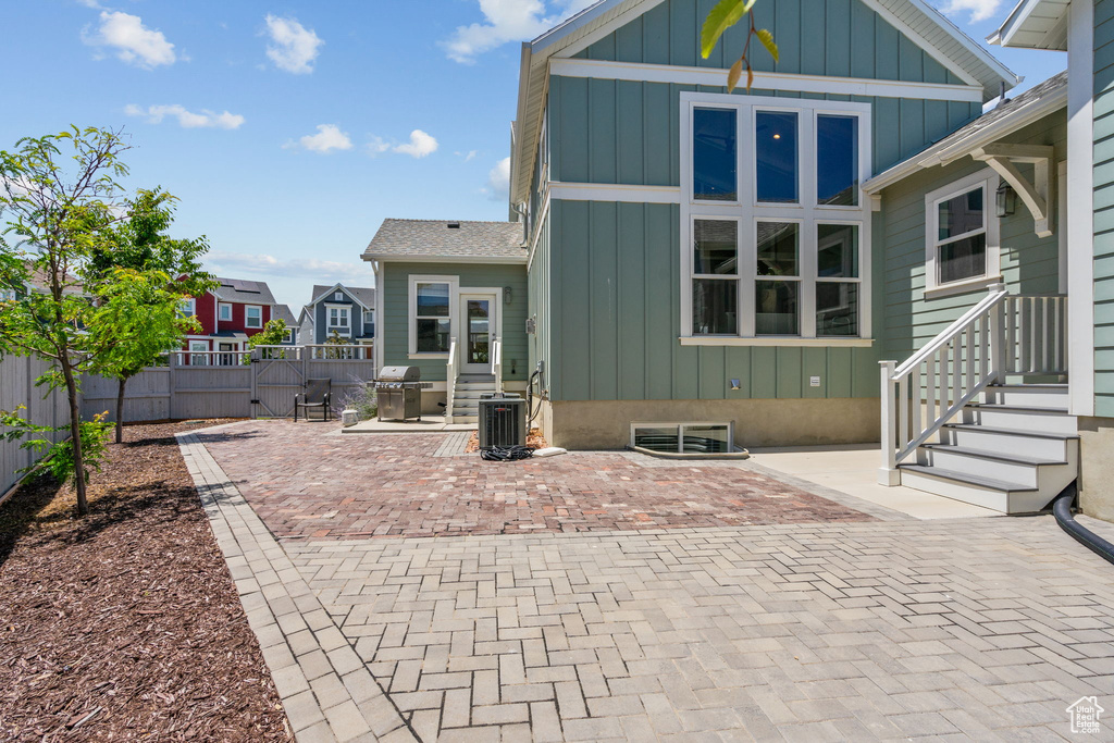 Rear view of house featuring board and batten siding and a patio area