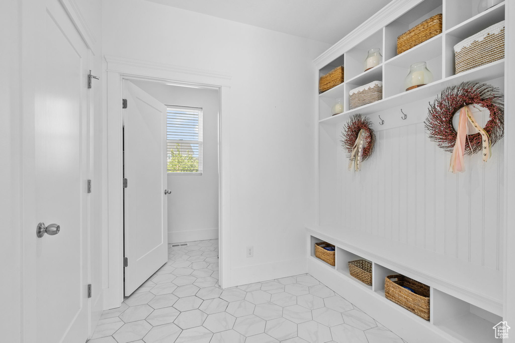 Mudroom with light tile patterned floors