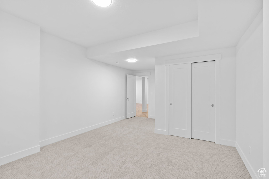 Unfurnished bedroom with carpet and a closet