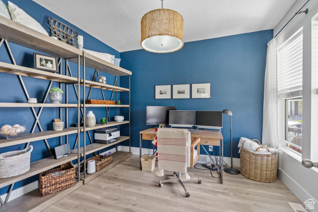 Home office with wood finished floors and baseboards