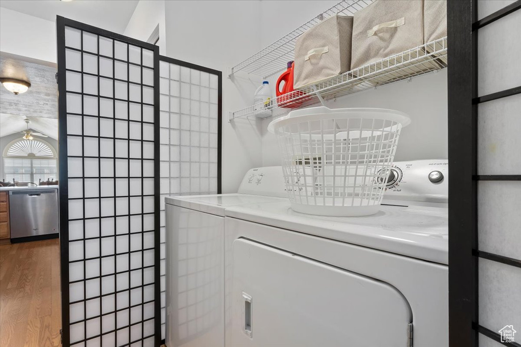Laundry room featuring washer and dryer and light wood-style flooring