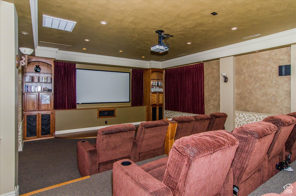 Home theater room featuring crown molding, carpet flooring, and recessed lighting