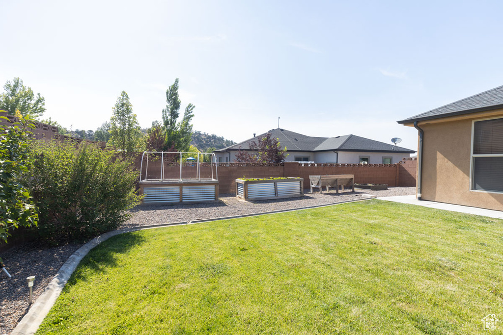View of yard featuring a garden and a patio area