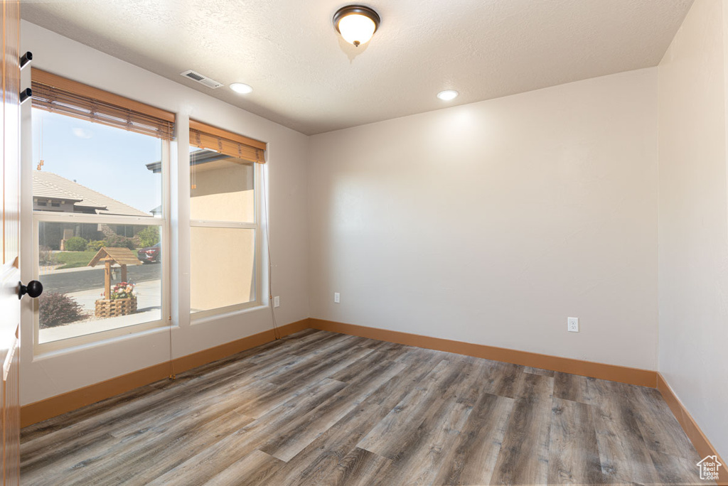 Empty room featuring wood finished floors and recessed lighting
