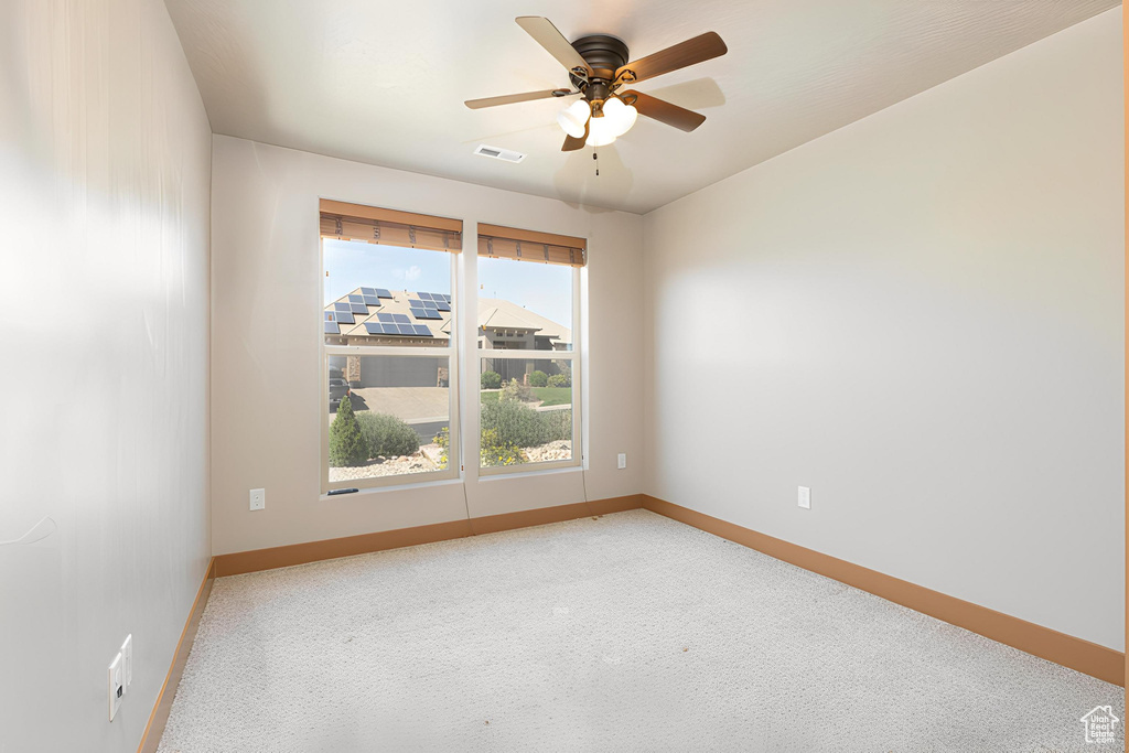 Spare room featuring ceiling fan and carpet flooring