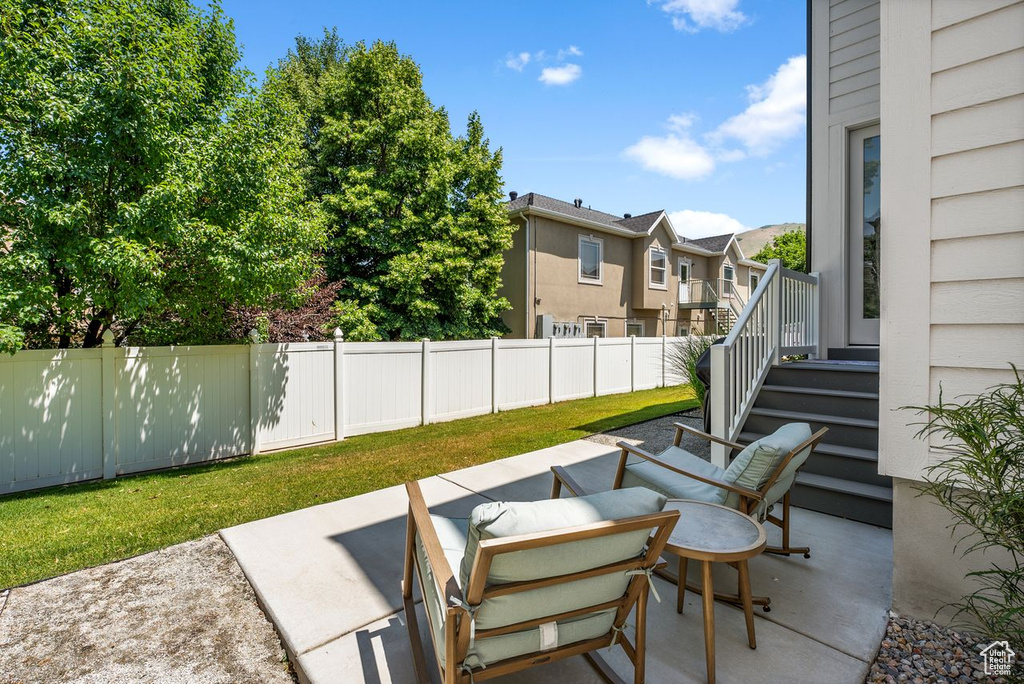 Fenced backyard with a patio and a residential view