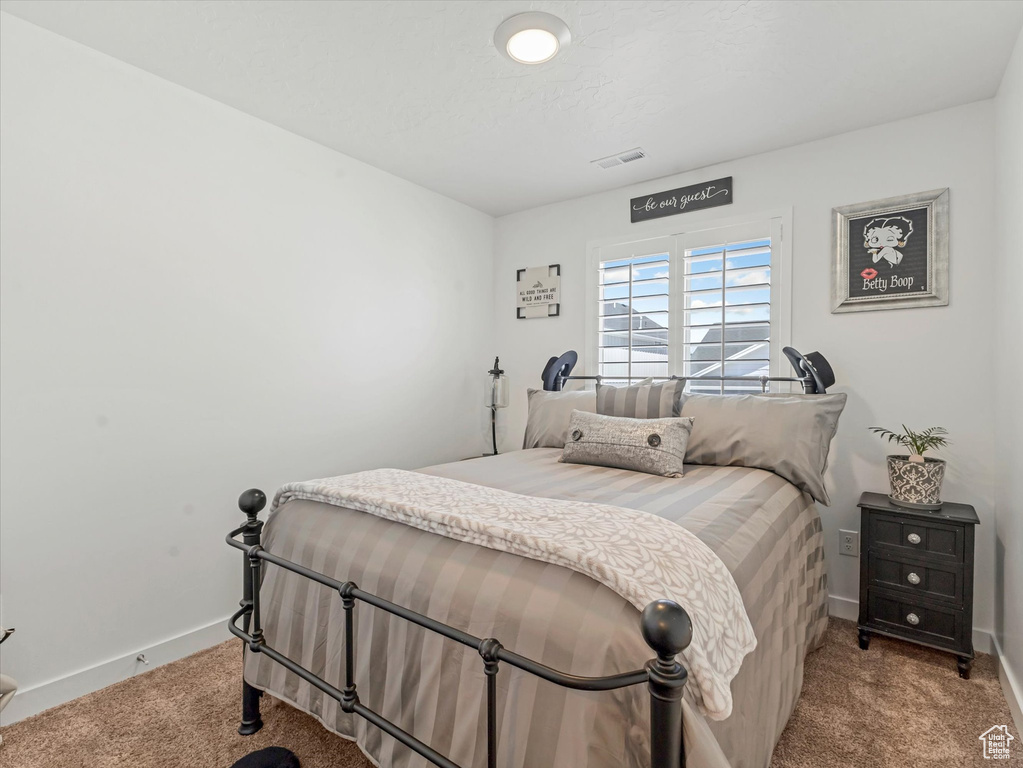 Carpeted bedroom featuring baseboards
