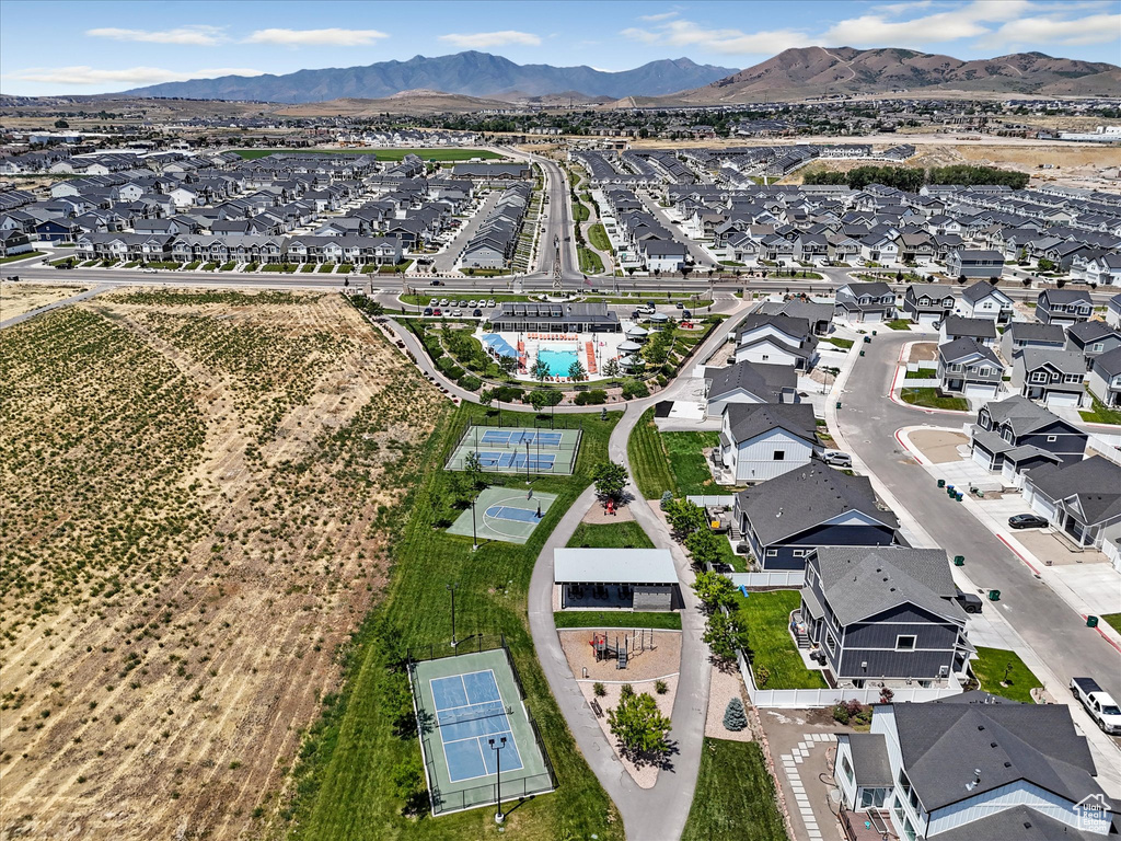 Aerial view of property's location featuring nearby suburban area and a mountainous background