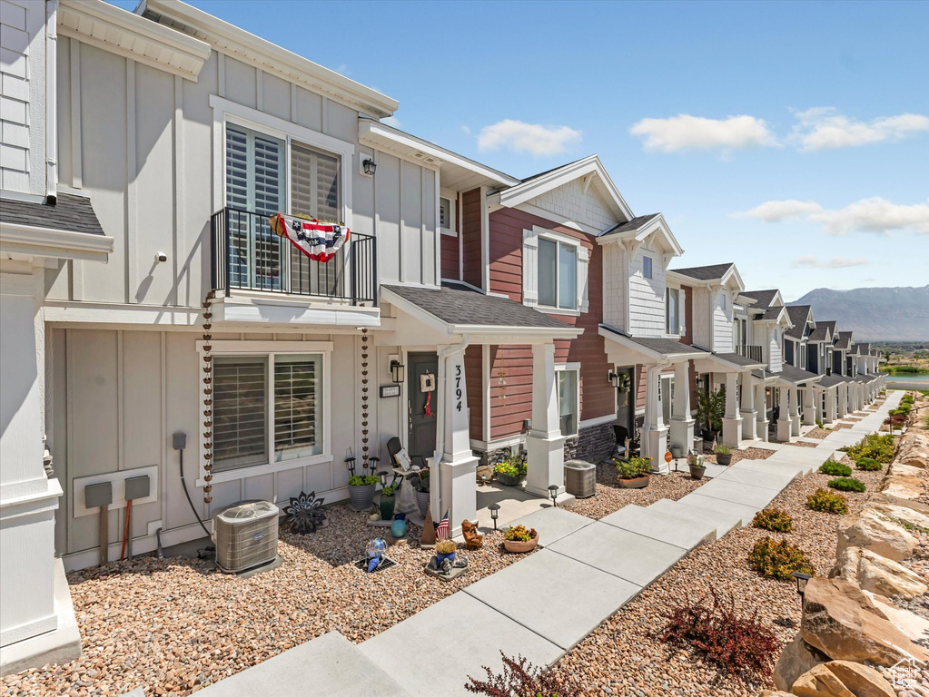 Multi unit property featuring board and batten siding, a residential view, and a mountain view
