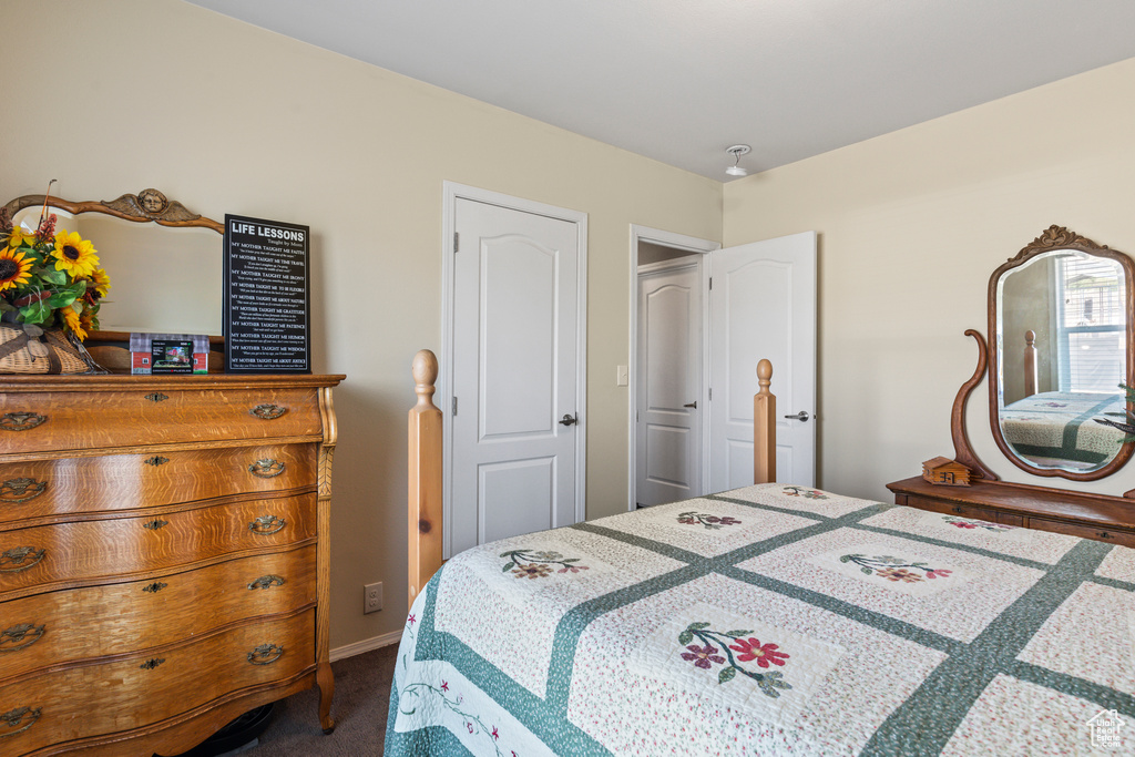 Bedroom with dark colored carpet