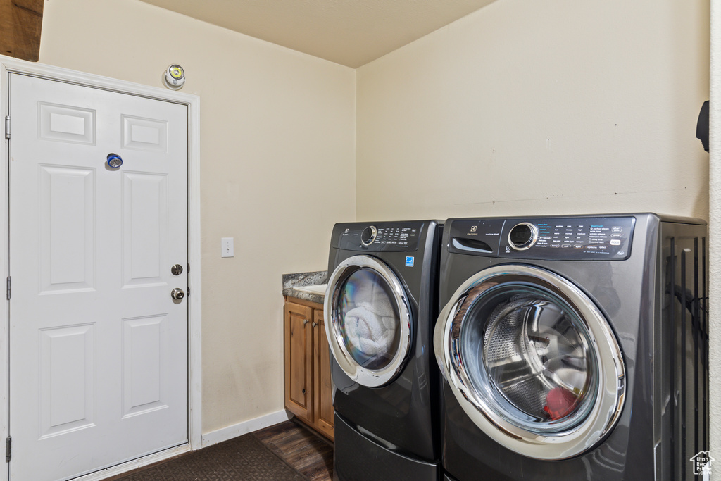 Laundry room with washing machine and clothes dryer and cabinet space