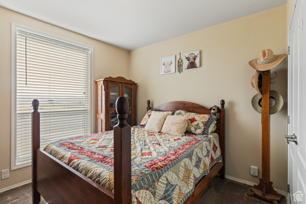 Bedroom featuring carpet floors and baseboards