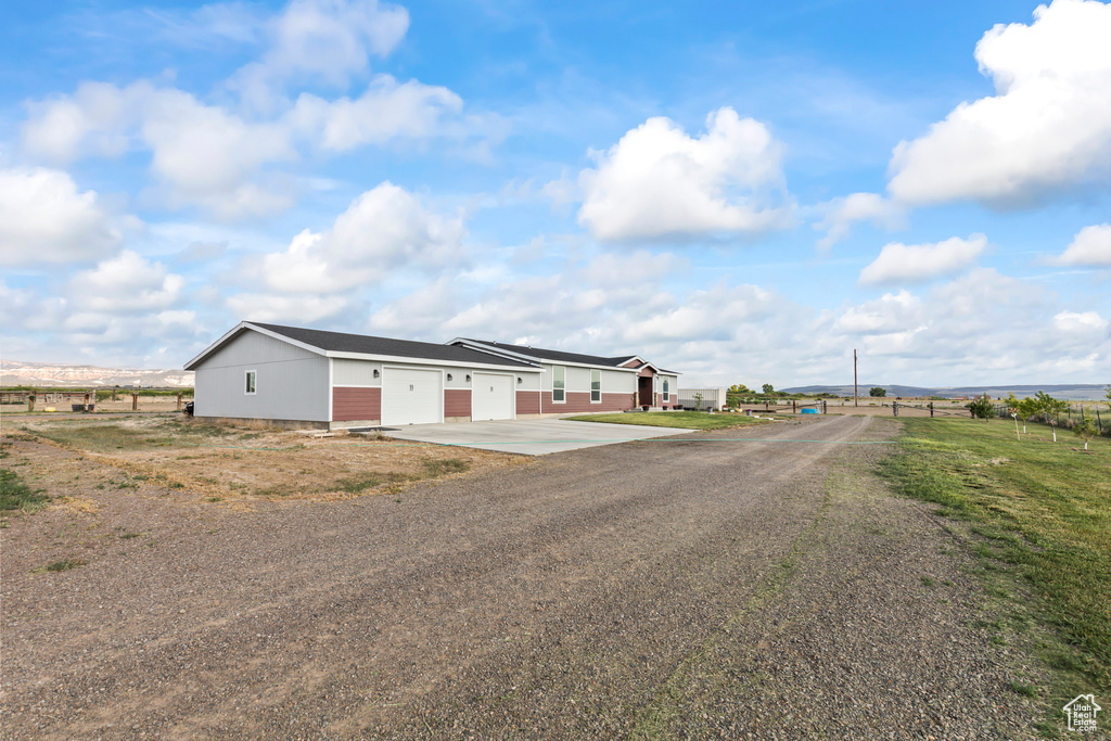 View of front facade featuring concrete driveway and a garage
