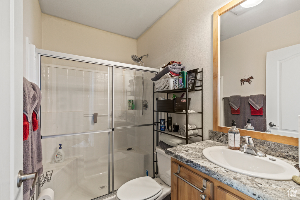 Full bath featuring a stall shower and vanity