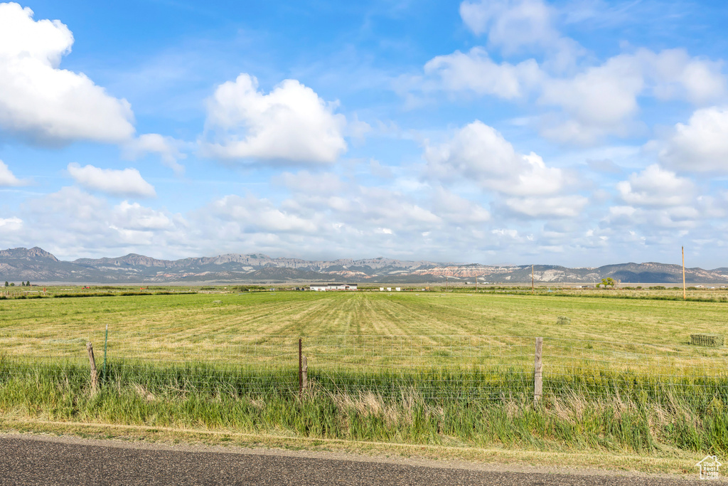 View of mountain backdrop with rural landscape and agricultural land