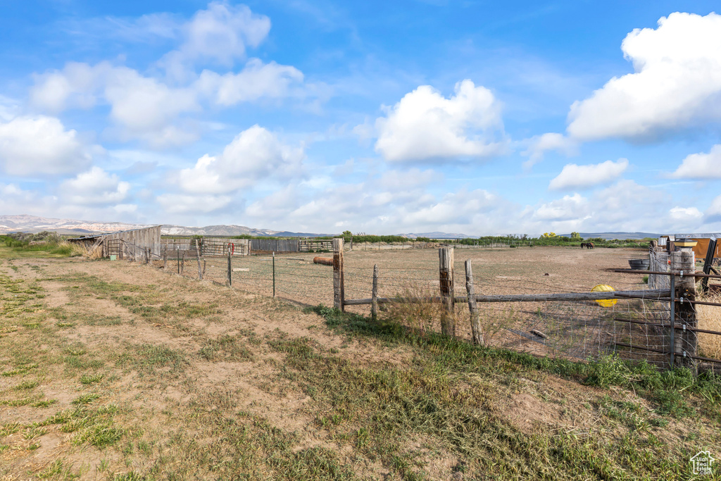 View of yard featuring a view of rural / pastoral area and a mountain view
