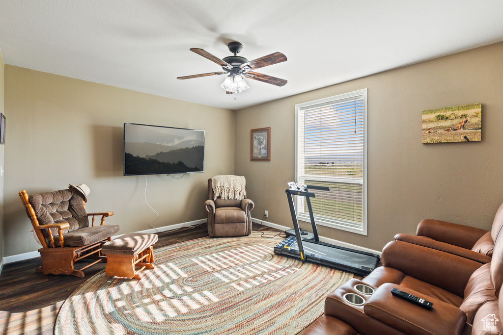 Living room with wood finished floors and a ceiling fan
