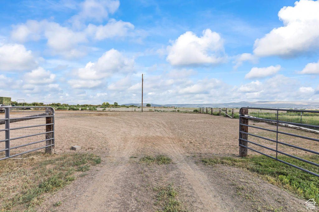 View of street featuring a rural view and a gated entry