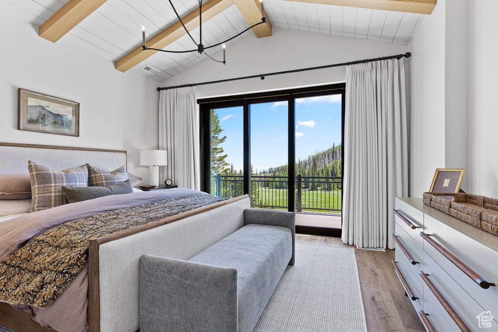 Bedroom featuring light wood finished floors, access to exterior, and wooden ceiling