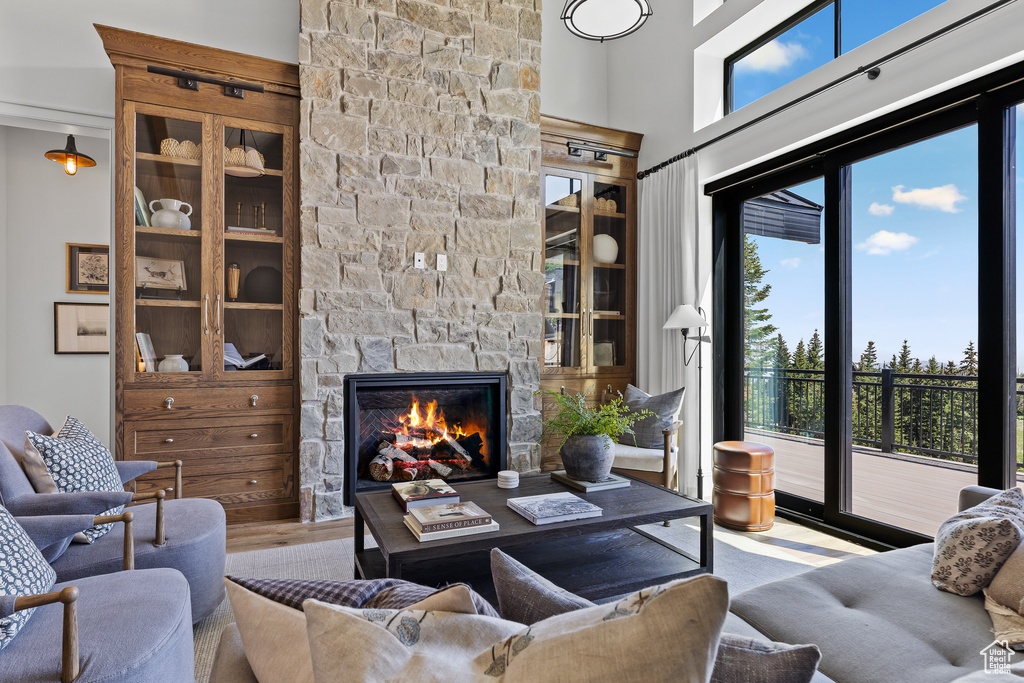 Living room with plenty of natural light, a fireplace, and wood finished floors